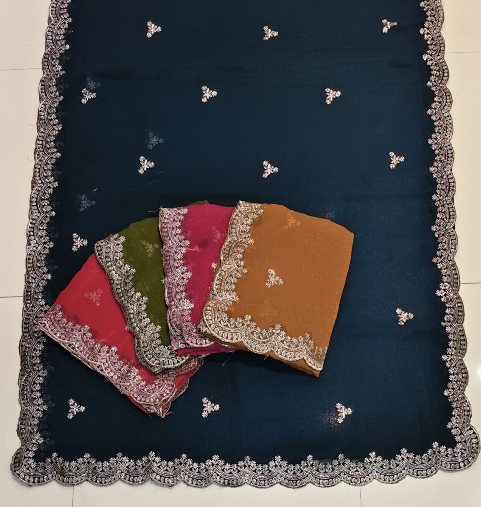 Designer embroidered saree collection featuring pink, green, mustard, and red shades. Each saree has a rich scalloped lace border with silver floral embroidery, displayed on a dark blue base saree. Perfect for party wear, festive occasions, weddings, and traditional functions.